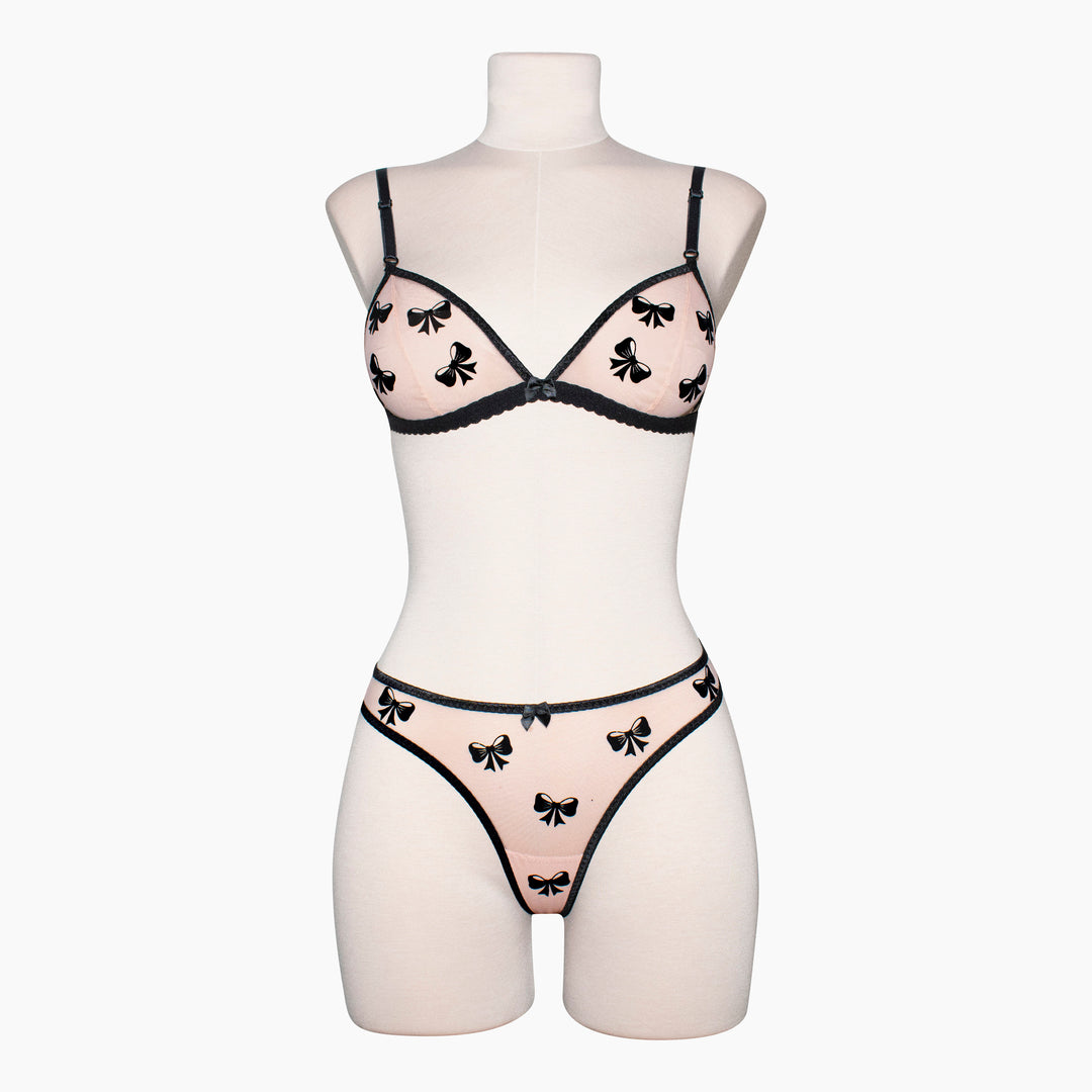 Peachy pink sheer mesh bralette with black velvet bow appliqué