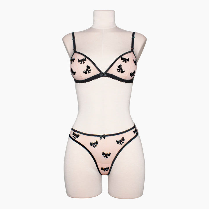 Peachy pink sheer mesh bralette with black velvet bow appliqué